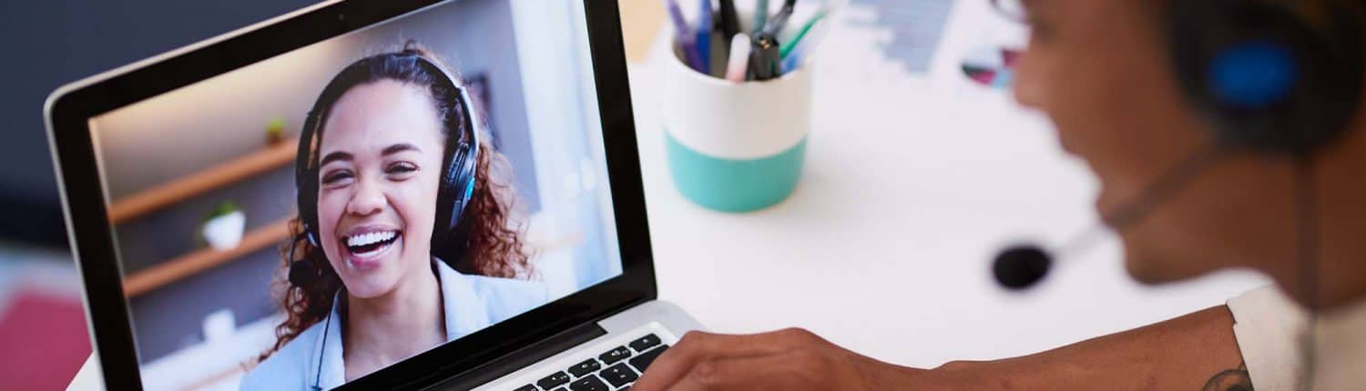 Close up of video screen with a conference call between two young people at work