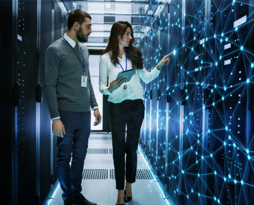 Female and Male IT Engineers Discussing Technical Details in a Working Data Center